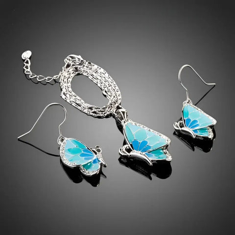 Silver butterfly necklace and earrings set with blue enamel wings and rhinestones