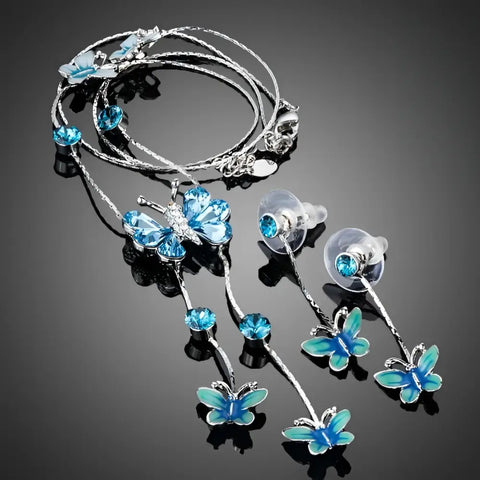 Elegant silver butterfly necklace and earrings set with blue crystals