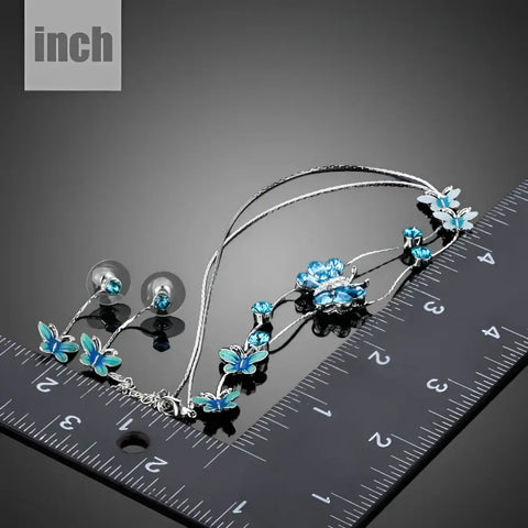 Silver butterfly necklace and earrings set with blue enamel and crystals