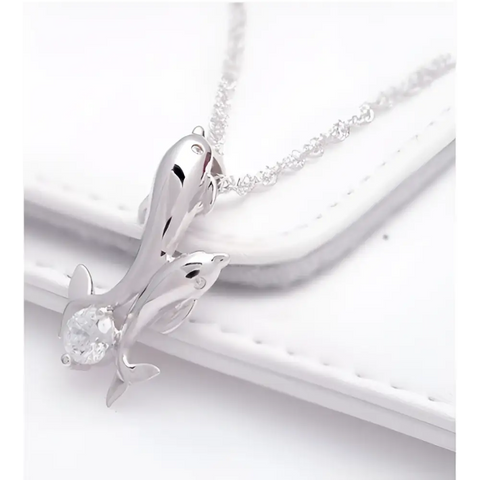 Silver dolphin pendant necklace with sparkling crystals, symbol of love and ocean harmony