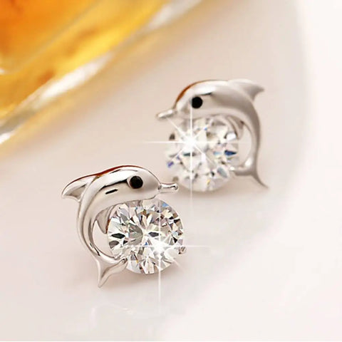 Silver dolphin stud earrings with crystal center, symbol of protection