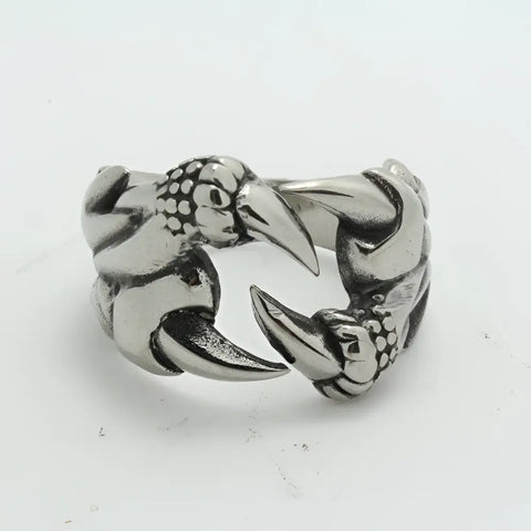 Silver dragon ring with claw talons, scales; symbol of strength, protection