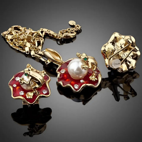 Gold-toned frog earrings and pendant set with red enamel lily pads, pearl, green eyes, rhinestones. Good luck symbol
