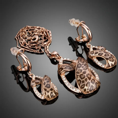 Rose gold leopard-print dangle earrings with crystal accents, clip-back