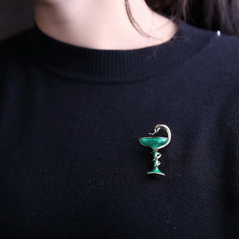 Snake over cup brooch