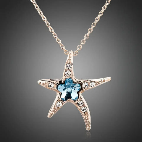 Silver starfish pendant necklace with blue crystal center, clear crystals, ocean protection design