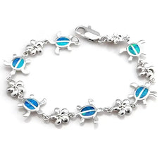 Silver turtle charm bracelet with blue opal inlays, symbol of protection