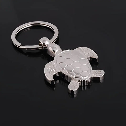 Silver turtle keychain with polished finish, detailed shell, symbol of protection