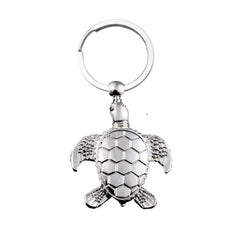 Silver turtle keychain with hexagonal shell, detailed flippers, symbol of protection