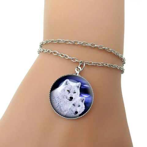 Wolf bracelet: silver chain with pendant of two white wolves on moonlit blue background