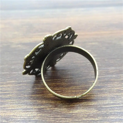 Antique brass wolf ring with ornate butterfly filigree, symbol of protection